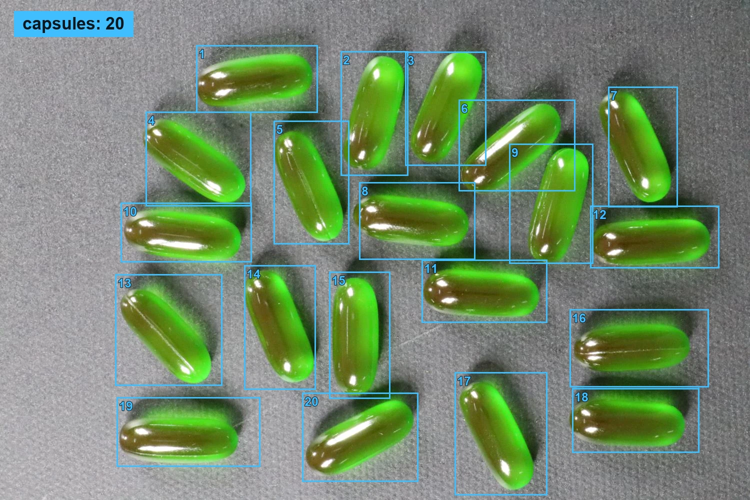 20 grüne Kapseln mit nummerierten blauen Boxen und eingeblendeter Gesamtzahl.